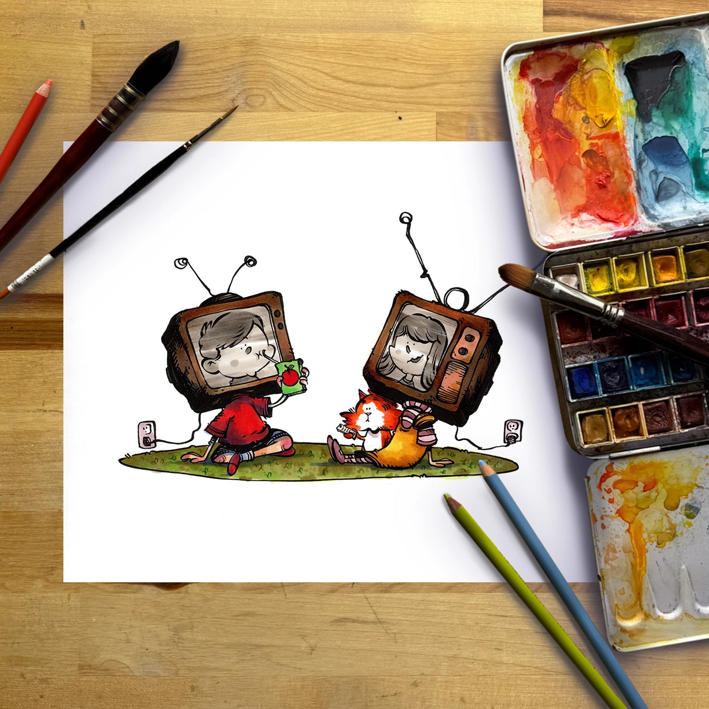 A white sheet of paper on a wooden desk featuring a hand-drawn cartoon illustration of two children with retro television sets, surrounded by art supplies including paintbrushes, watercolor paints, and colored pencils.