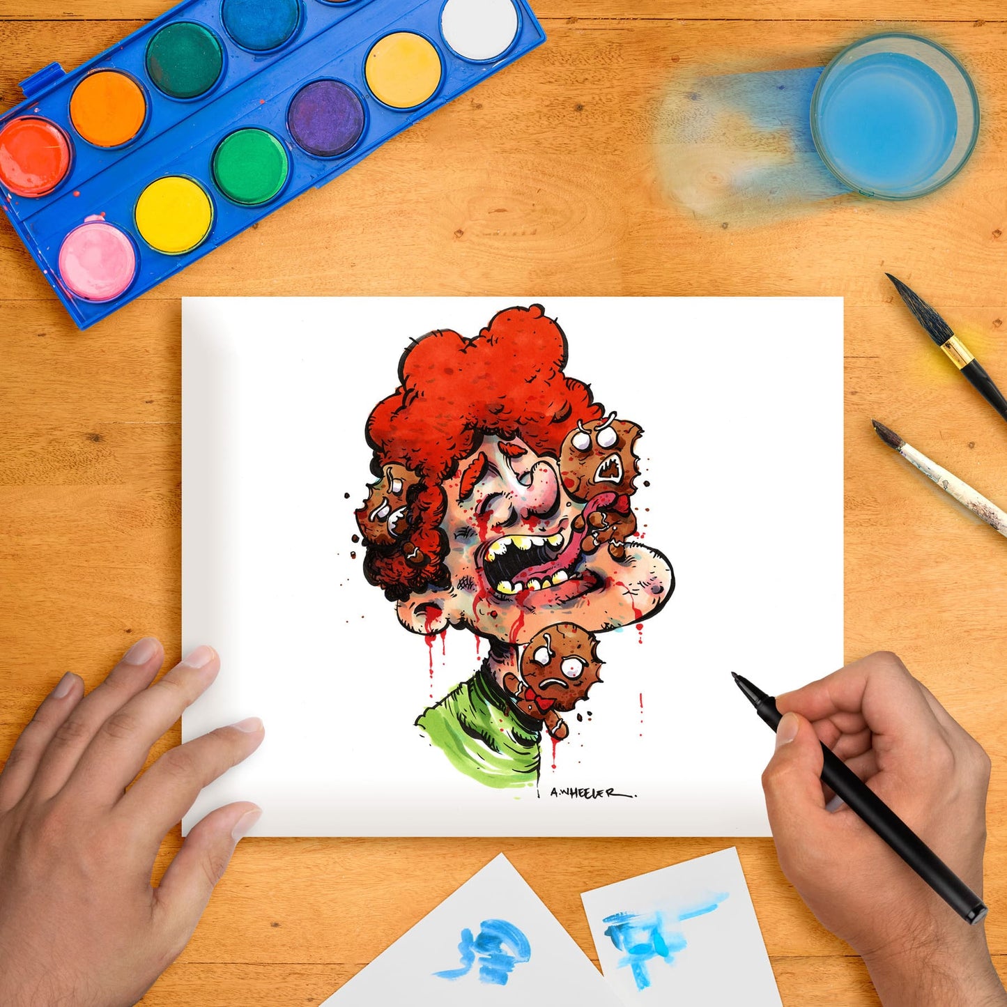 Original marker illustration artwork on paper depicting a cartoonish character with red hair, placed on a table with art supplies around.