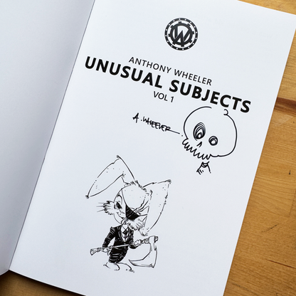 Signed Anthony Wheeler’s Unusual Subjects Vol. 1 book page with skull doodle and black-and-white rabbit character illustration.