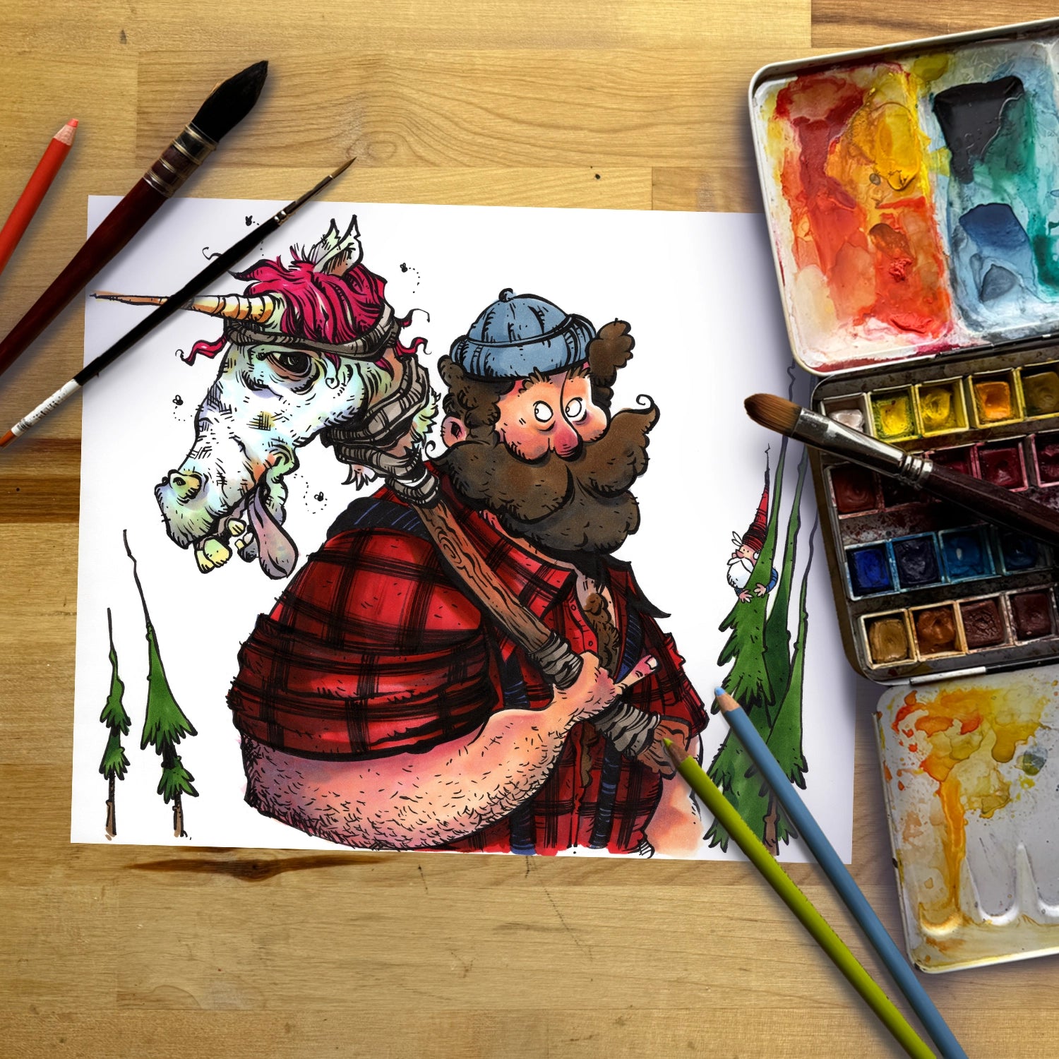 A whimsical hand-drawn illustration on a white sheet of paper, showing a bearded man in a red plaid shirt carrying a unicorn on his shoulders, surrounded by paintbrushes, watercolor paints, and a paint palette on a wooden table.