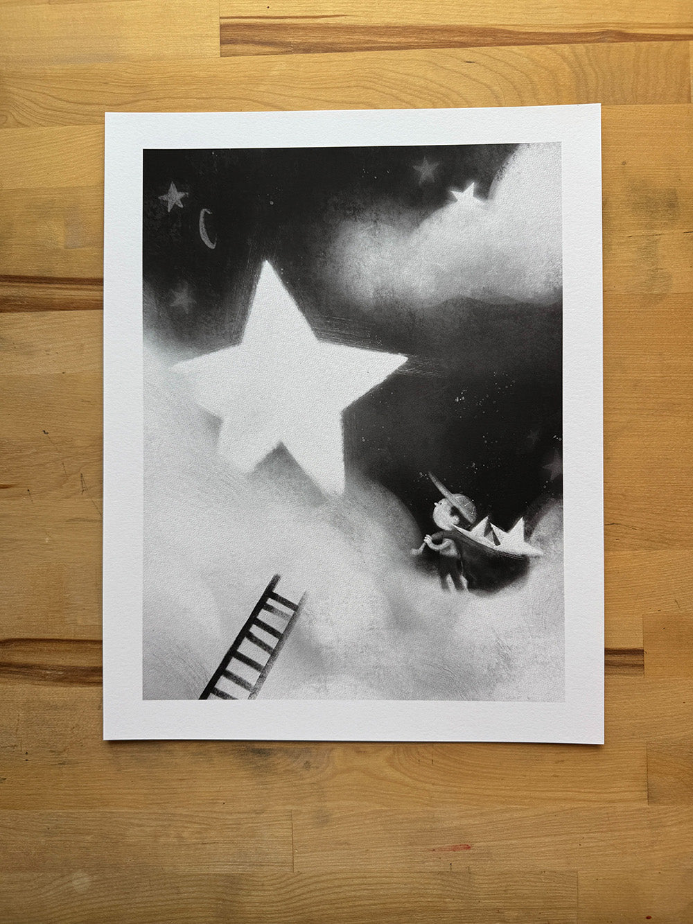 I Brought You Back the Star art print by Anthony Wheeler displayed flat on wooden table.