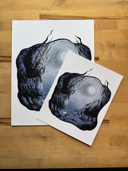 Anthony Wheeler Lost in the Woods art print shown in two print sizes on wooden table.