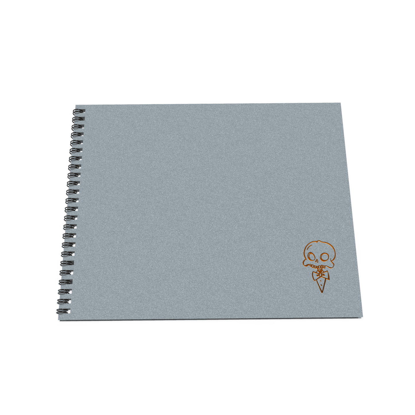 A gray sketchbook with a simple design on the cover, wire-o binding, and a stylized skull drawing.